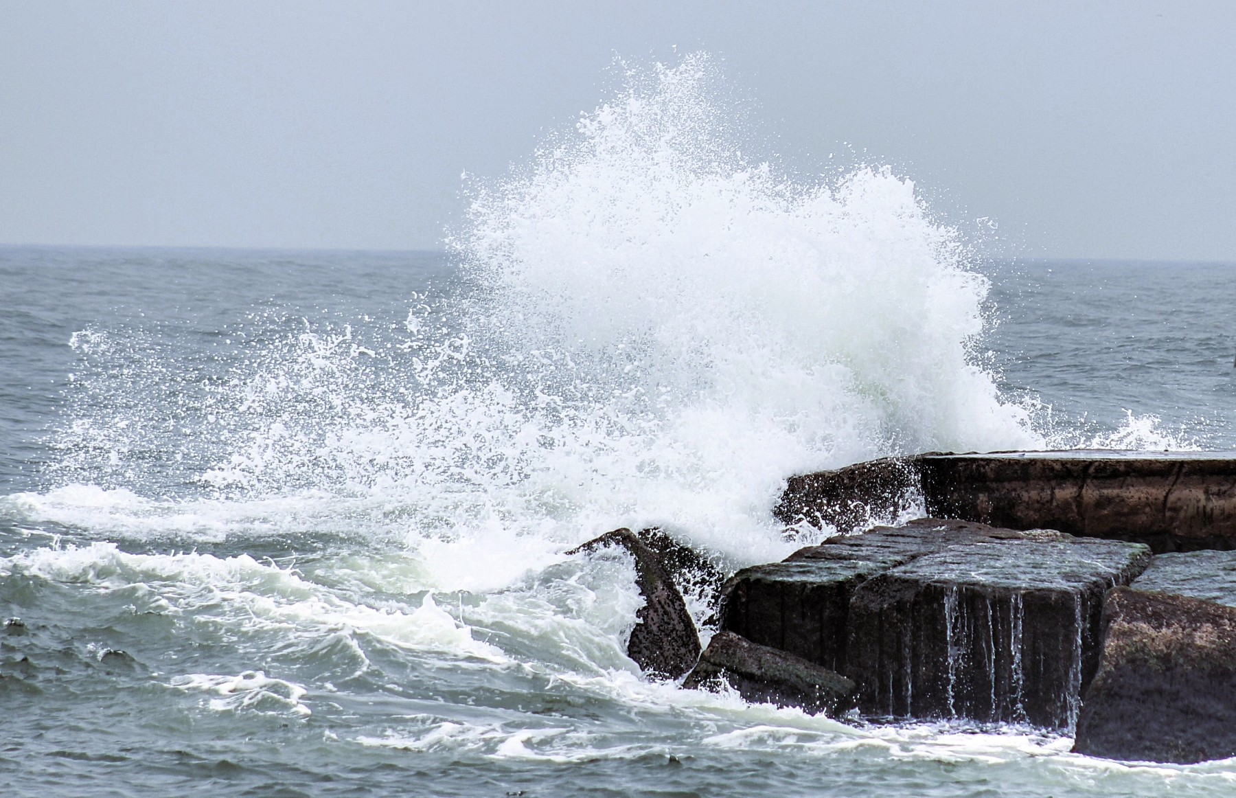 high waves spray over the pier at mustang island corpus christi texas